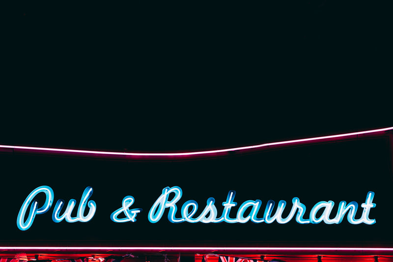 Bright neon pub and restaurant sign glowing at night